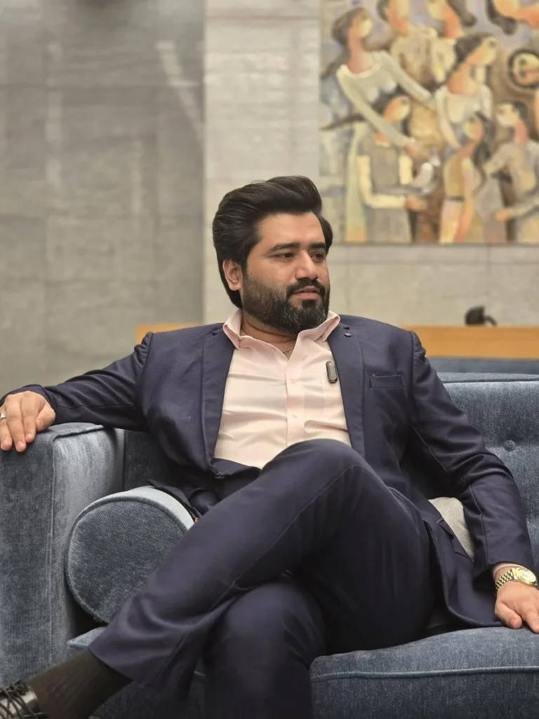 Ayaz Akram Awan, digital growth expert, seated in a navy suit